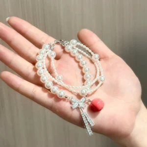 Multi-Strand Pearl Apple Bracelet – Sparkly Zircon Bow Tassel & Handcrafted Crimson Apple Charm